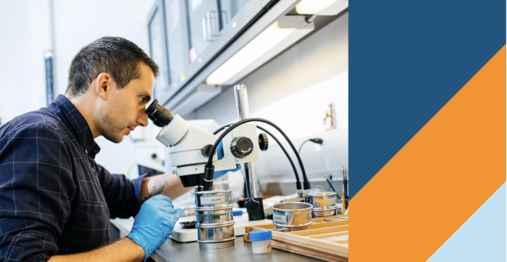 Man looking through lab magnifier